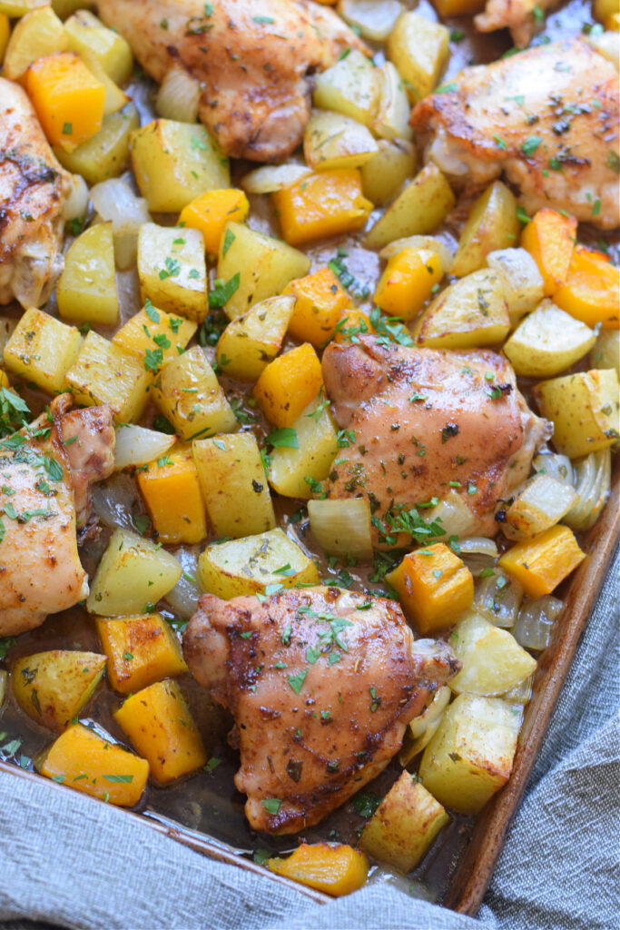 Old Bay sheet pan chicken and squash on a baking tray.