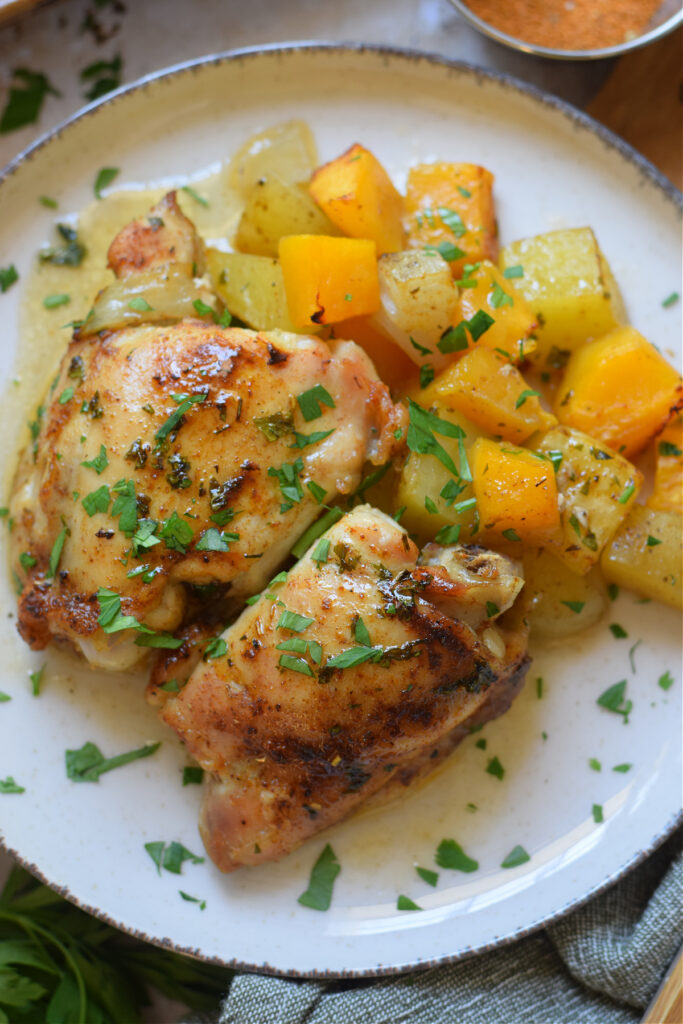Chicken and fall vegetables on a plate.