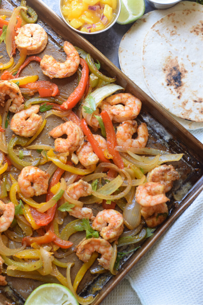 Shrimp and peppers on a baking tray.