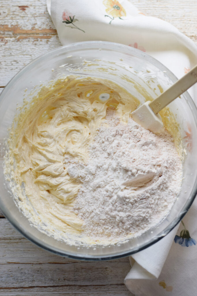 Folding in flour into cake batter.