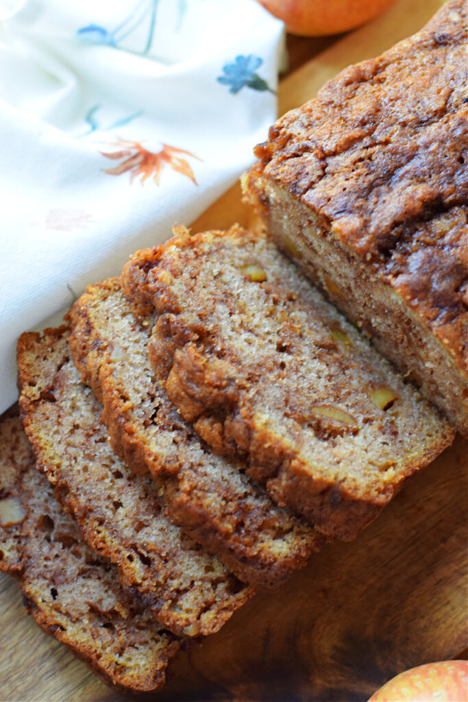 Close up of an apple cinnamon loaf cake cut into slices.