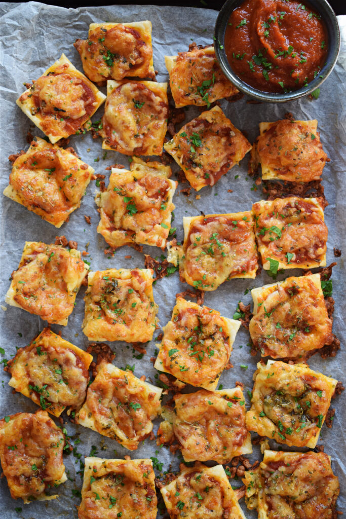 Pizza bites on a tray.