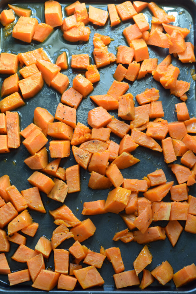 Roasted sweet potatoes on a tray.