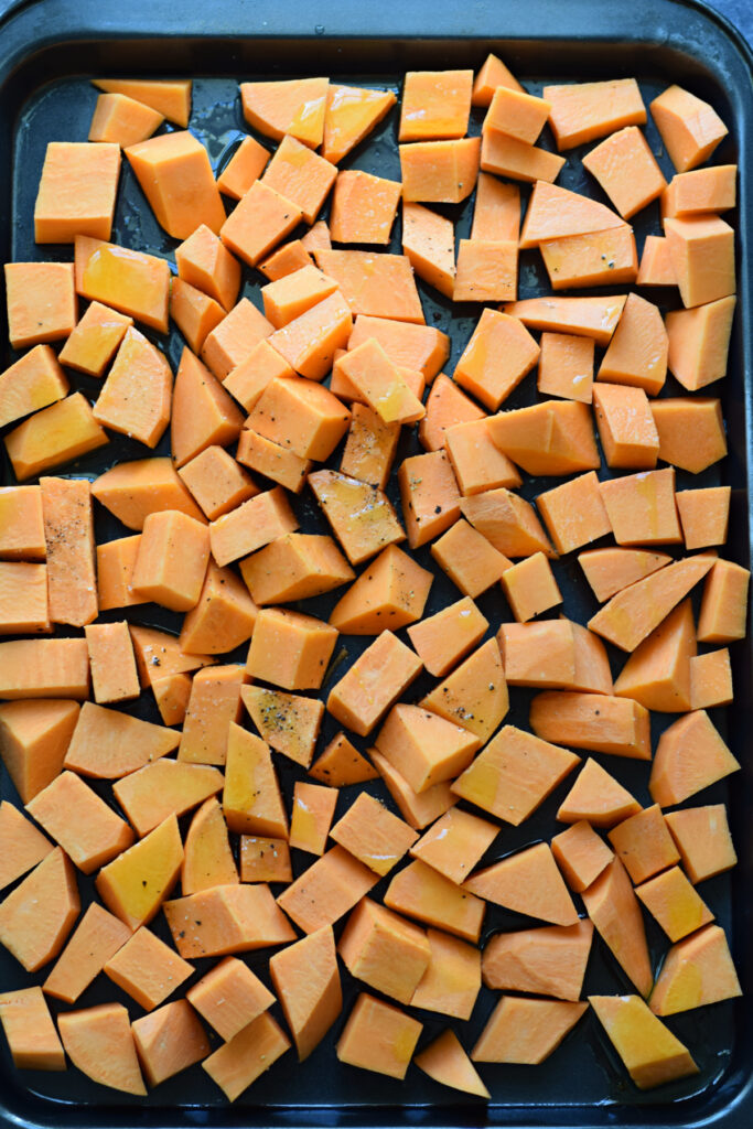 Diced sweet potatoes on a baking tray.