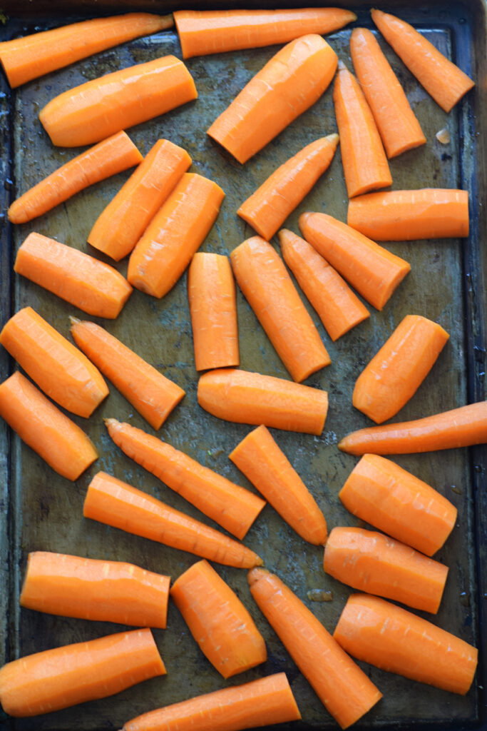 Raw carrots on a baking tray.