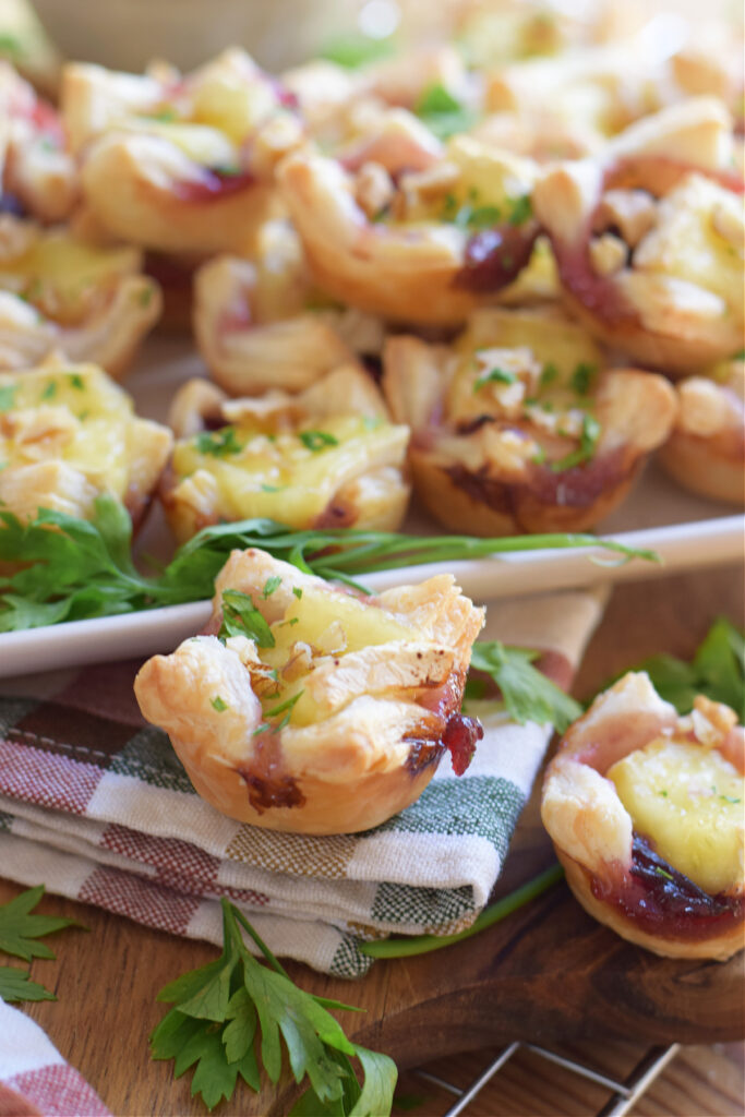 Mini puff pastry appetizers on a tray.