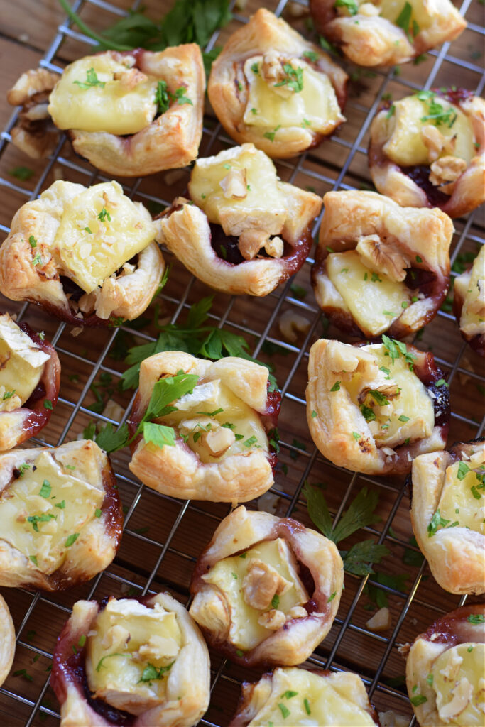Bake brie and cranberry bites on a tray.