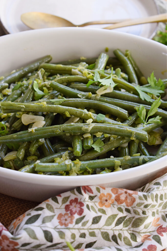 Green beans close up in a white serving dish.