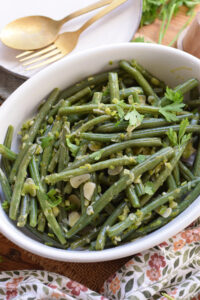 Green beans in a white dish.