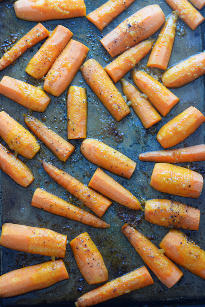Roasted carrots on a baking tray.