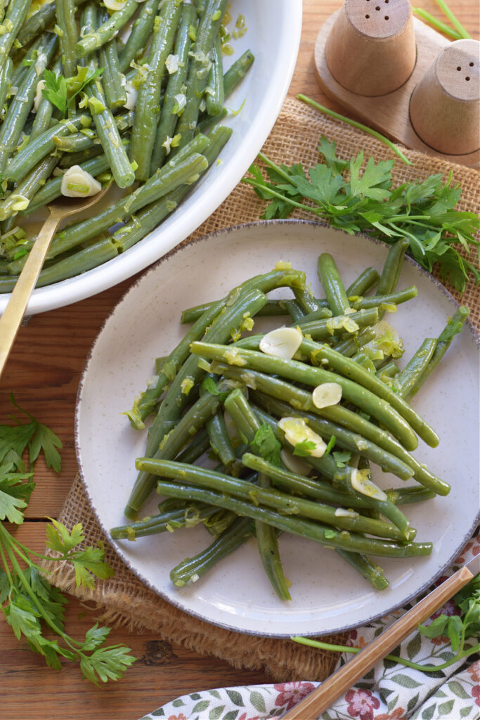 Green beans on a plate and in a serving dish.