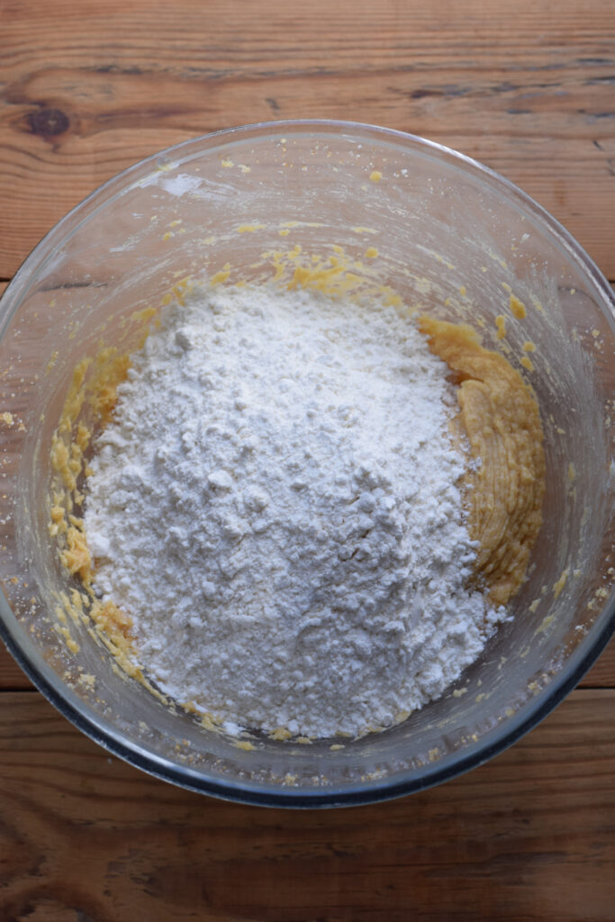 Adding flour to cookie dough.