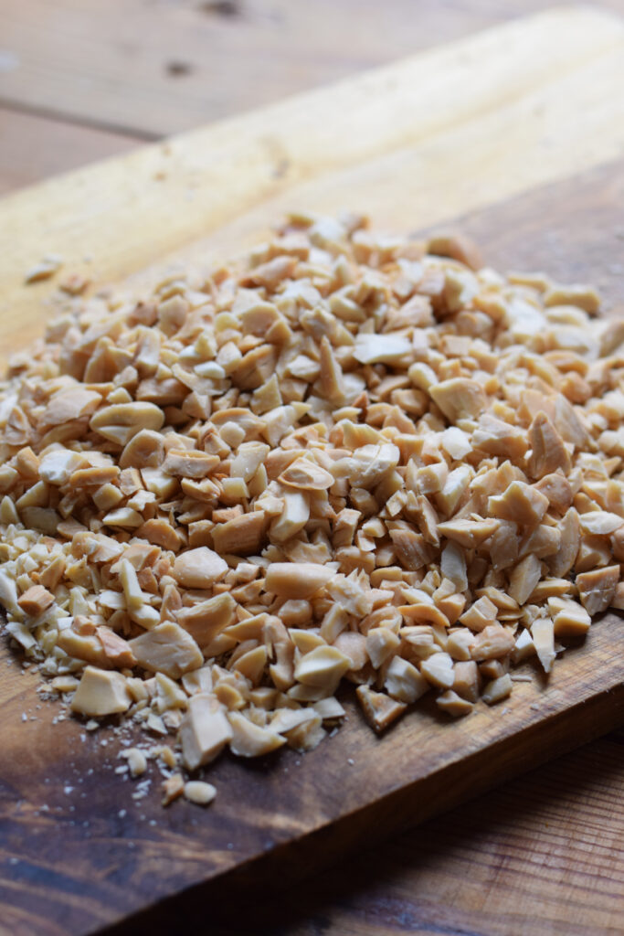 chopped almonds on a wooden board.