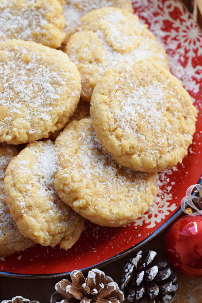 Close up of chewy coconut cookies on a red plate.