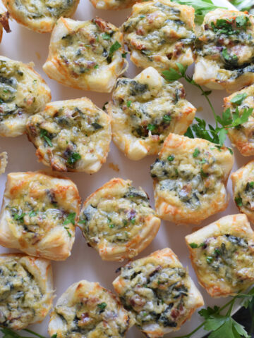 Spinach puffs on a white plate.