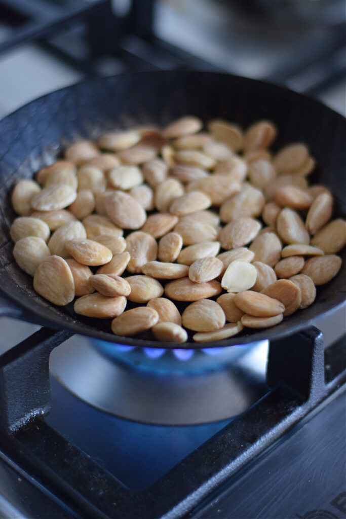 Toasting almonds in a skillet.