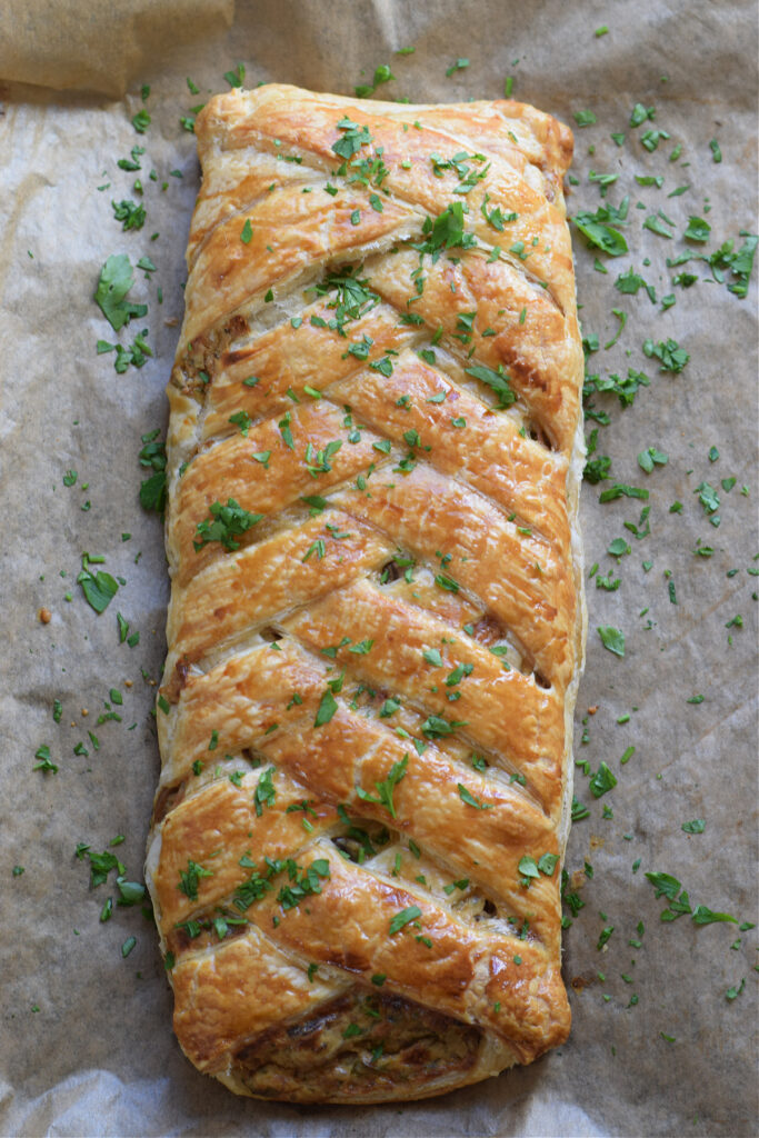 Mushroom filled pastry braid on a baking tray.