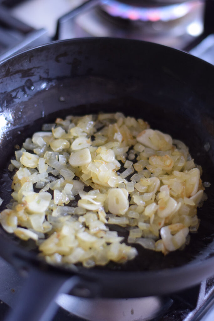 Cooking onions and garlic in a skillet.