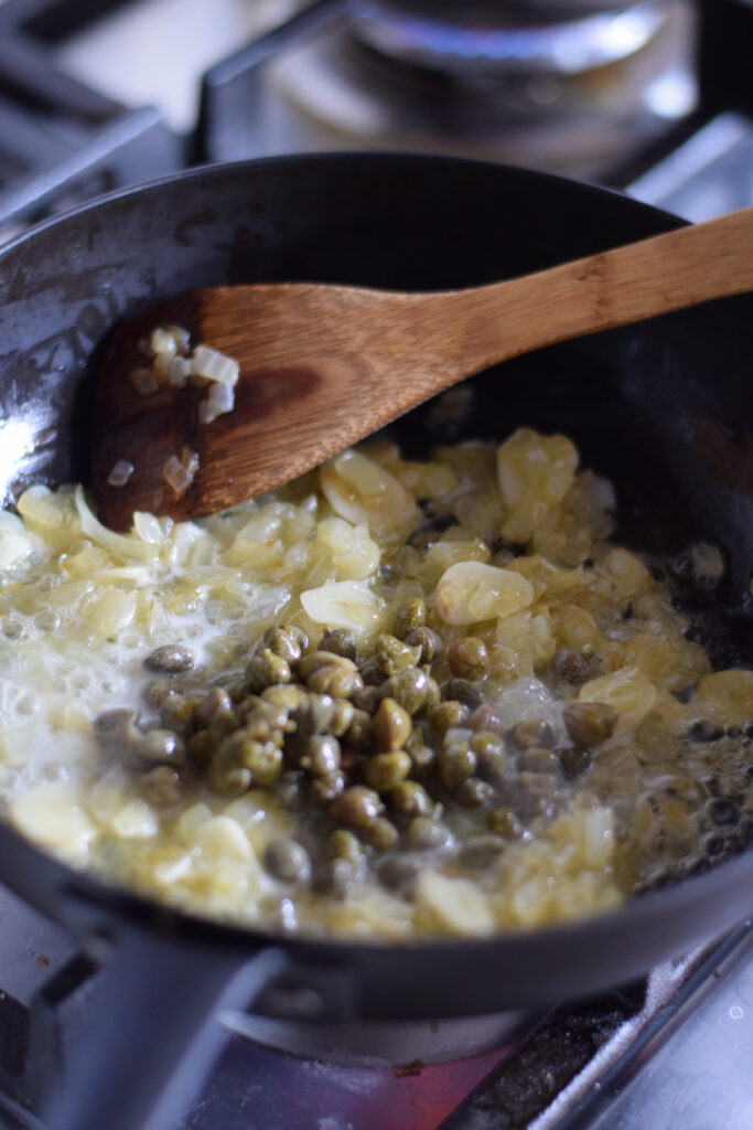 Cooking capers with onions and garlic.