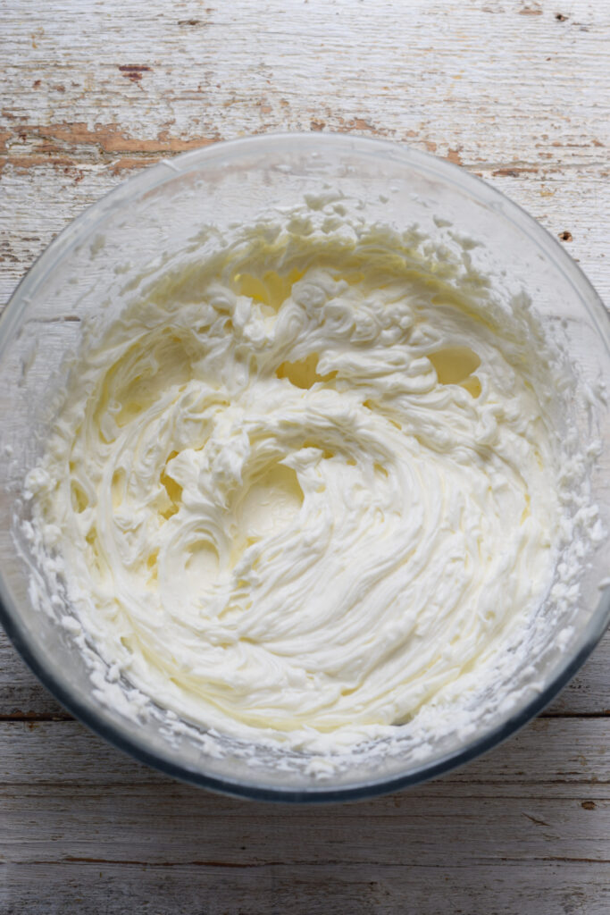 Mixed sugar and cream cheese in a bowl.