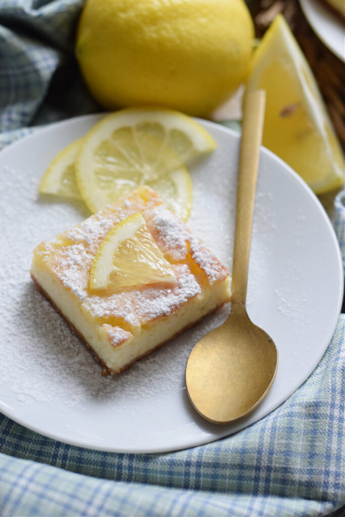 Lemon cheesecake bar on a plate.