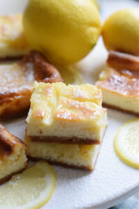 Lemon cheesecake bars on a plate.