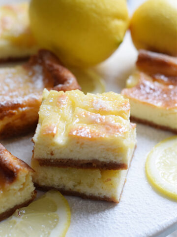 Lemon cheesecake bars on a plate.