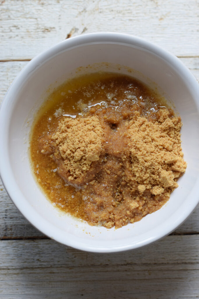 Cookie crumbs and melted butter in a bowl.
