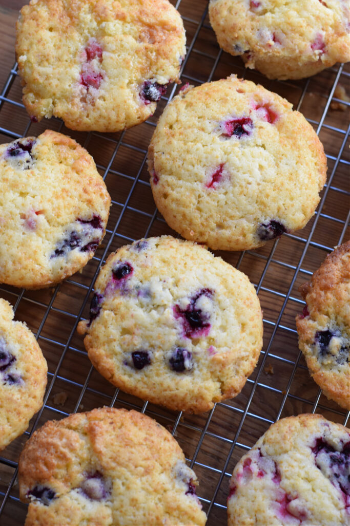 Berry muffins on a baking rack.