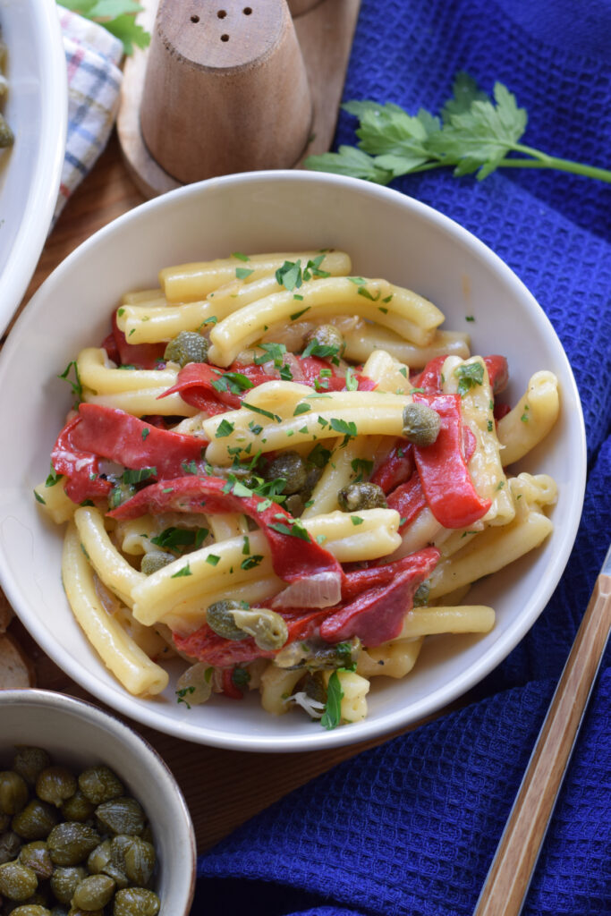 Red pepper pasta with capers in a bowl.