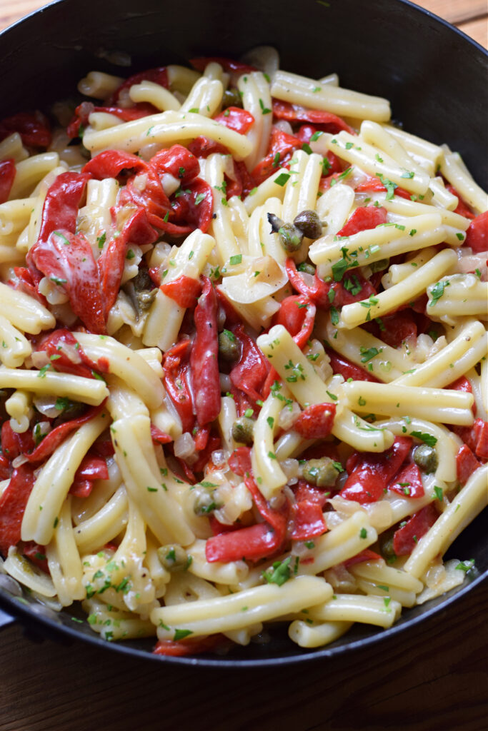 Red pepper pasta in a skillet.