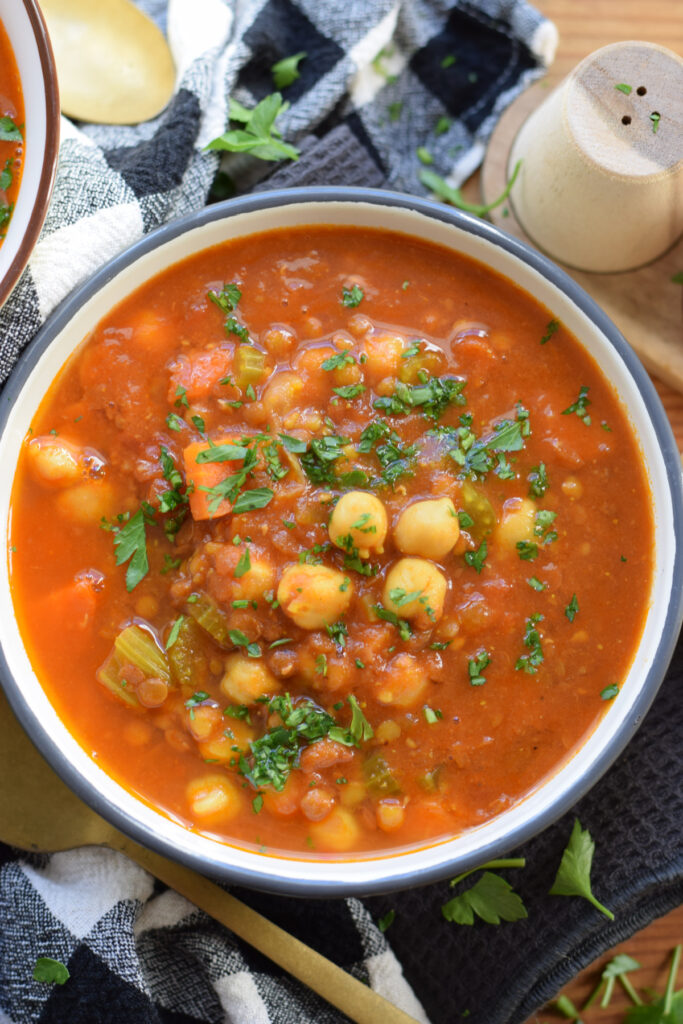 Spiced soup with chickpeas in a bowl.