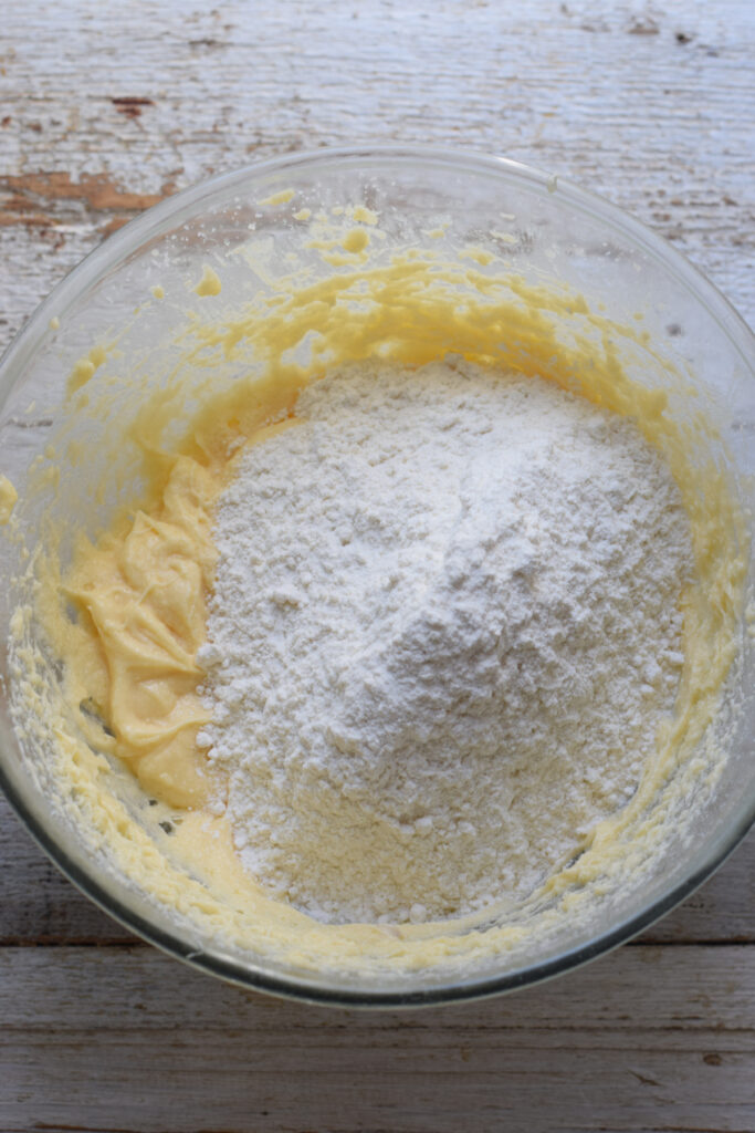 Adding flour to muffin batter.