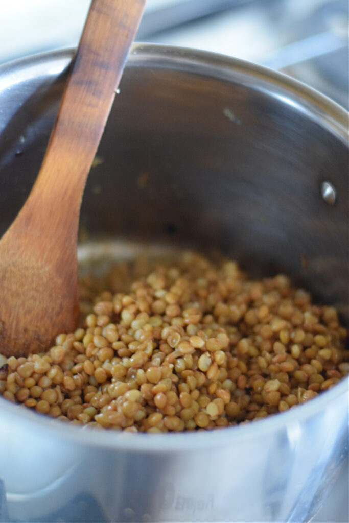 Adding lentils to soup.