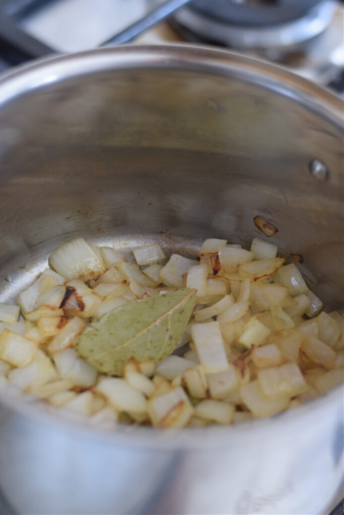 Cooking onions in a pot.