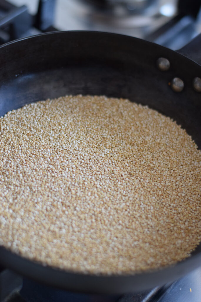 Cooking quinoa in a medium sized skillet.