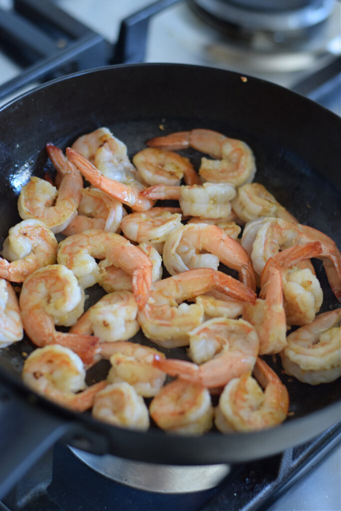 Cooked shrimp in a skillet.