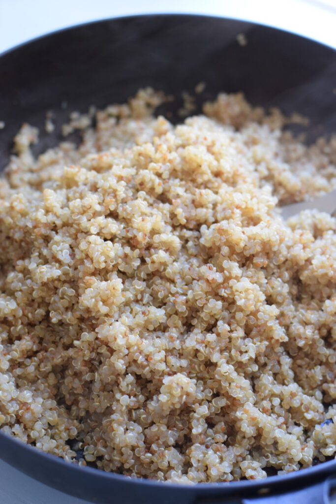 Fluffed quinoa in a skillet.