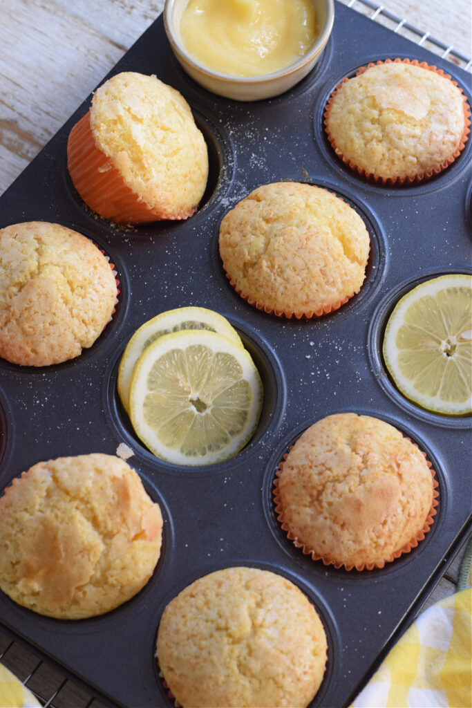 Muffins in a tray with lemon slices.