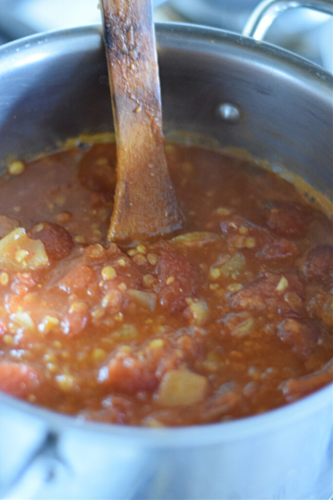 Tomato lentils soup in a pot.