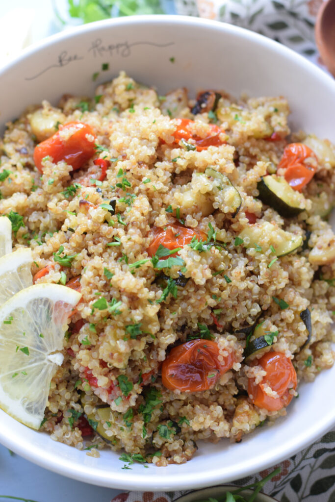 Roasted vegetable quinoa in a white bowl.