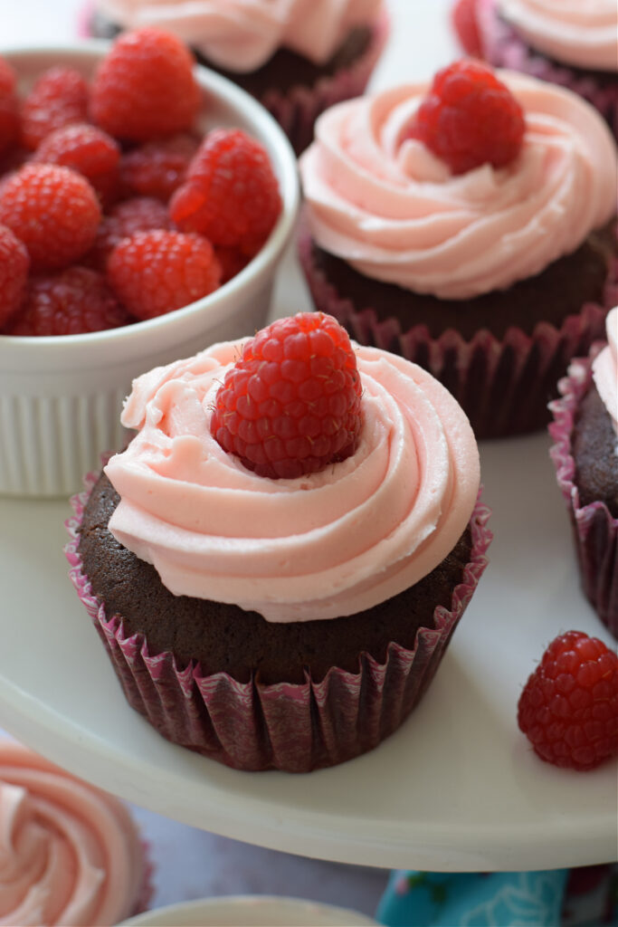 Close up of frosted topped cupcakes.