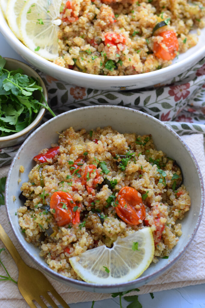 Quinoa dish in a bowl with roasted vegetables.