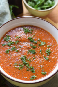 Close up of tomato and lentil soup in a bowl.