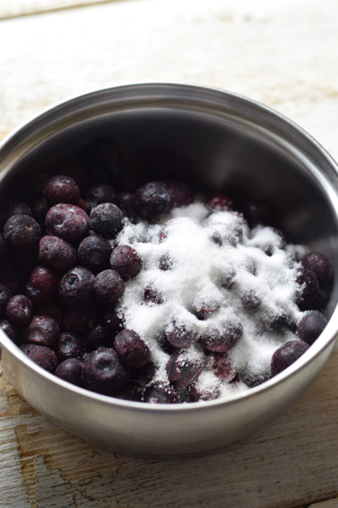 Making blueberry compote.