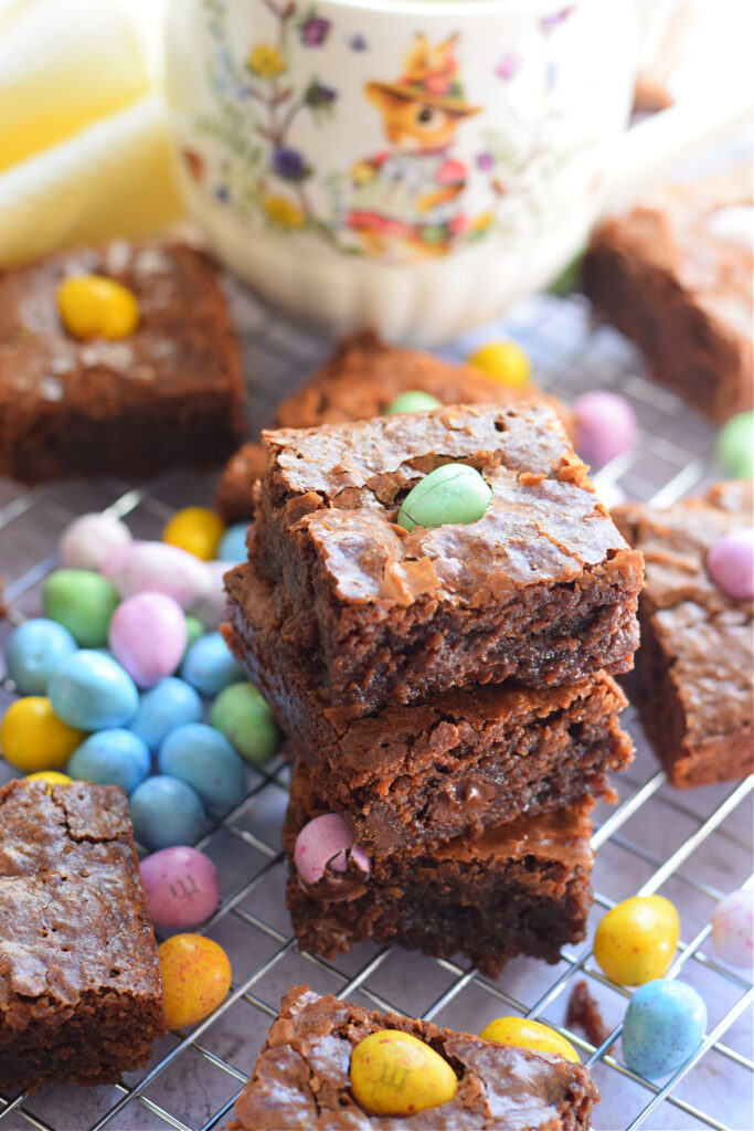 Mini egg brownies on a tray with a Easter mug.