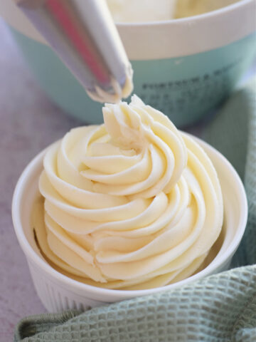 Buttercream frosting in a white bowl.