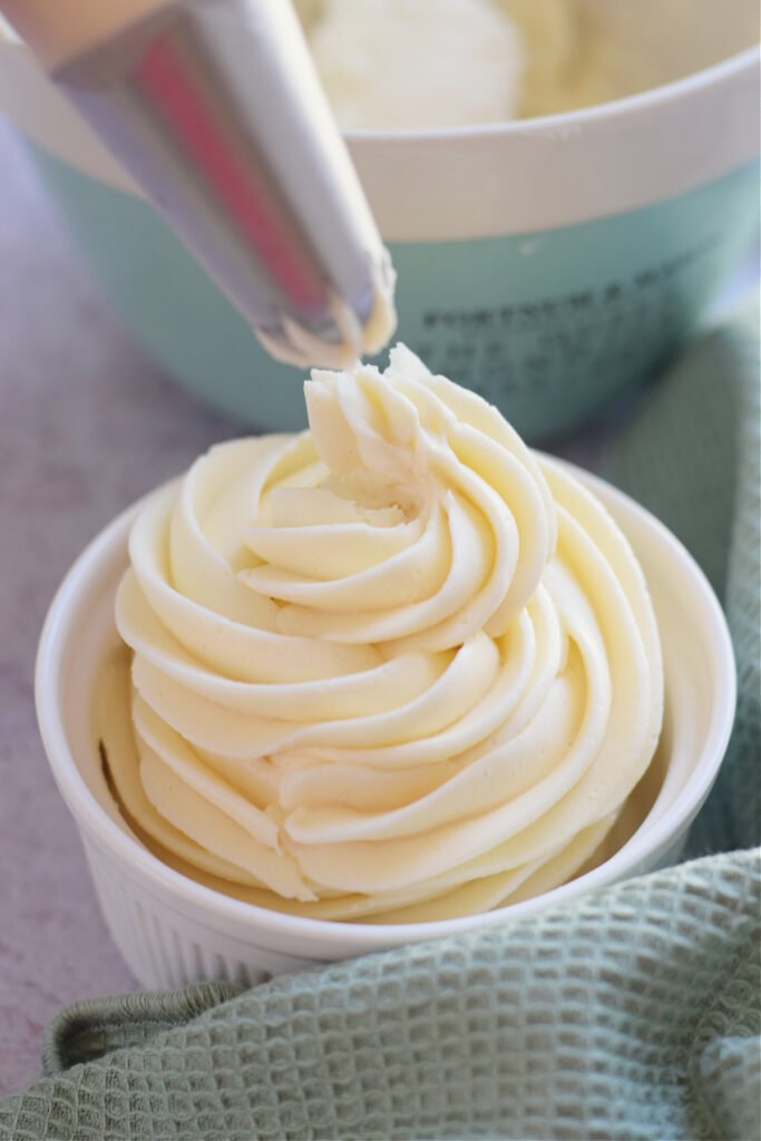 Buttercream frosting in a white bowl.