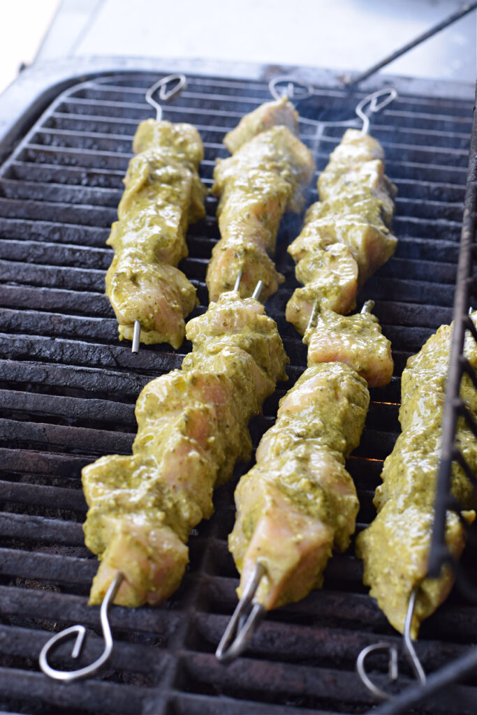 Cooking chicken kebabs on the grill.