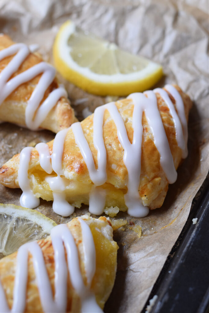 Close up of a lemon cream cheese turnover on a baking pan.
